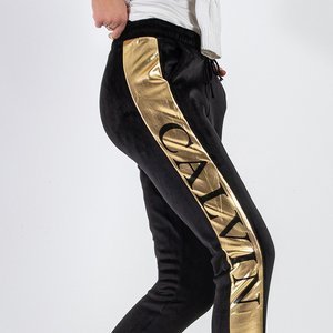 Black women's insulated sweatpants with gold piping - Odież